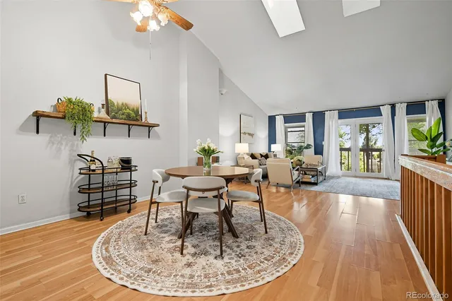 a living room with furniture a table and kitchen view