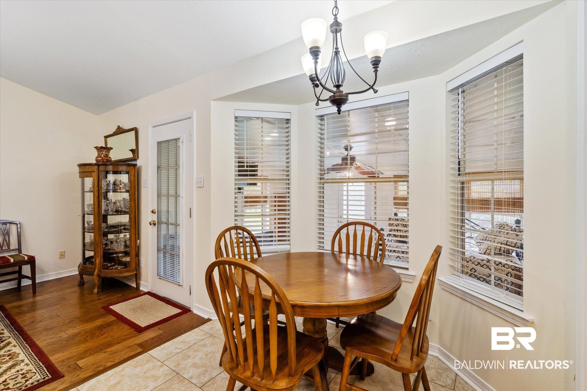 7236 Highpointe Place East Daphne, AL 36527 - Photo 11 of 32 Dining room with a healthy amount of sunlight, a notable chandelier, and light hardwood / wood-style floors