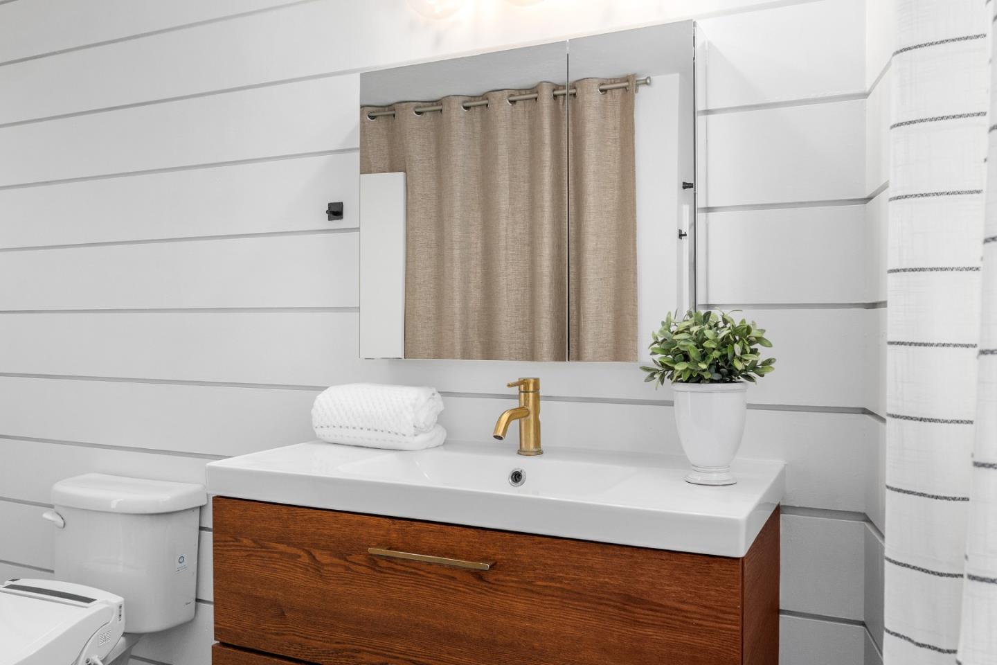 321 Valencia Road Aptos, CA 95003 - Photo 32 of 50 a bathroom with a sink and a mirror