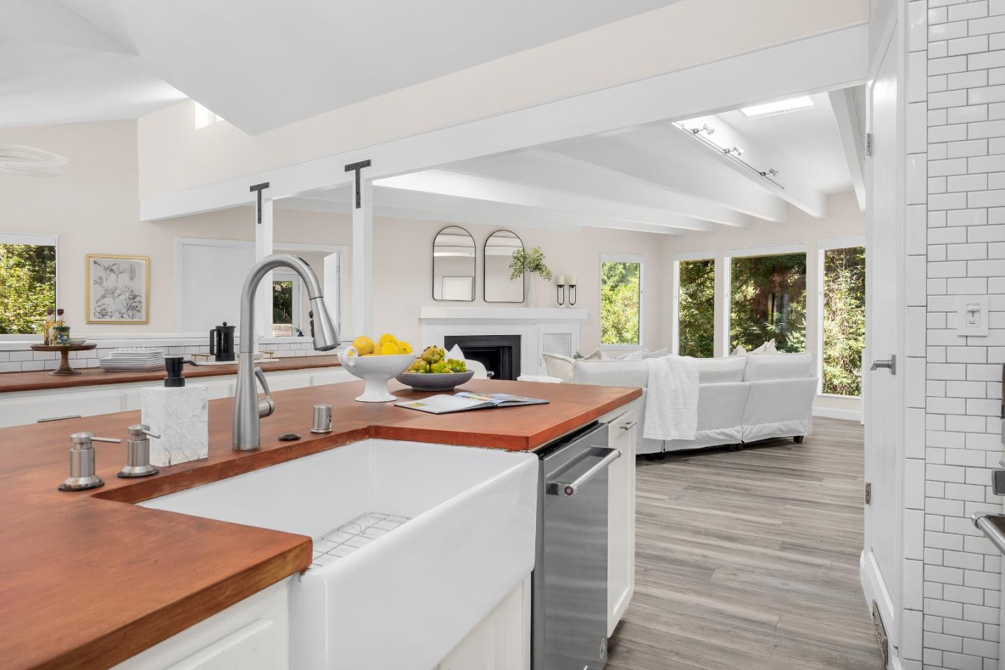 321 Valencia Road Aptos, CA 95003 - Photo 7 of 50 a view of a kitchen with kitchen island a stove a sink dishwasher and wooden cabinets with wooden floor