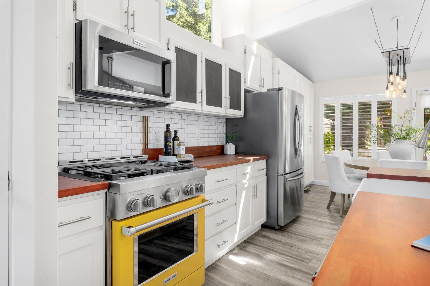 321 Valencia Road Aptos, CA 95003 - Photo 8 of 50 a kitchen with stainless steel appliances granite countertop a stove top oven a refrigerator a sink and dishwasher with wooden floor