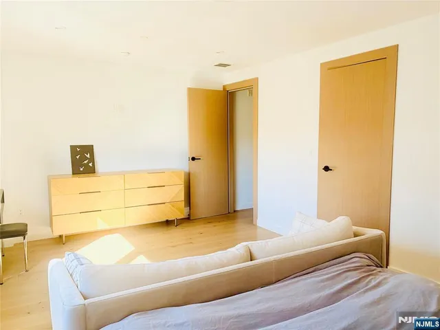 a bedroom with a bed and dresser