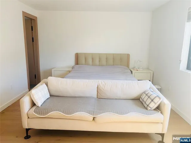 a bedroom with a bed and couch