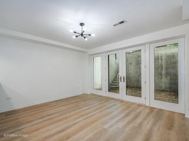 a view of an empty room with glass door