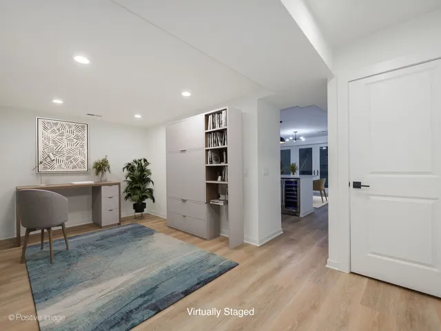 a view of a kitchen with furniture and wooden floor