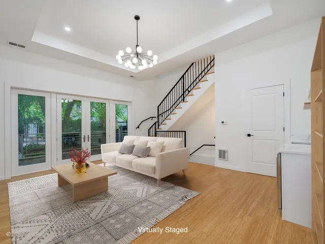 a living room with furniture and floor to ceiling windows