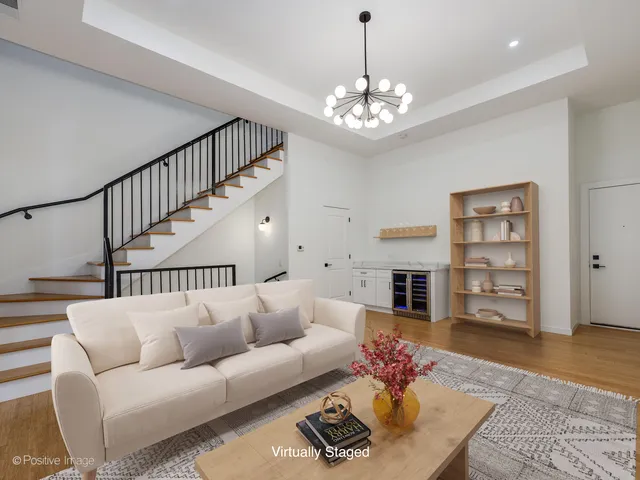 a living room with fireplace furniture and a chandelier