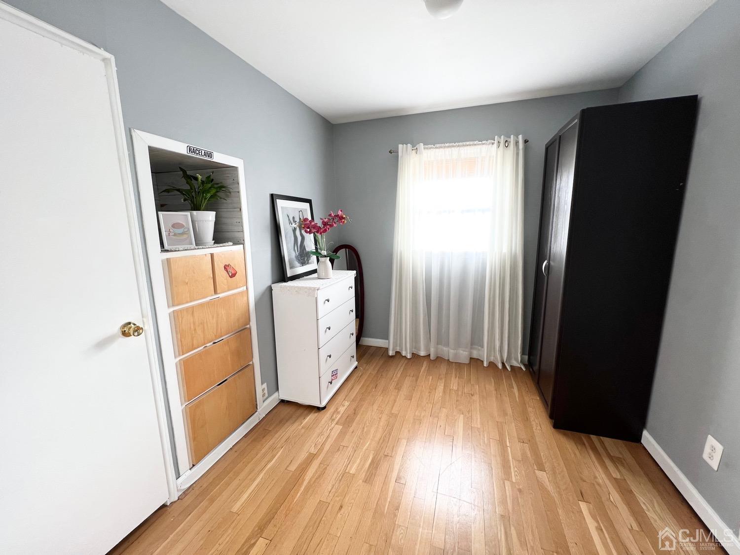 7 Wilshire Road Edison, NJ 08817 - Photo 11 of 14 wooden floor in an empty room with a window