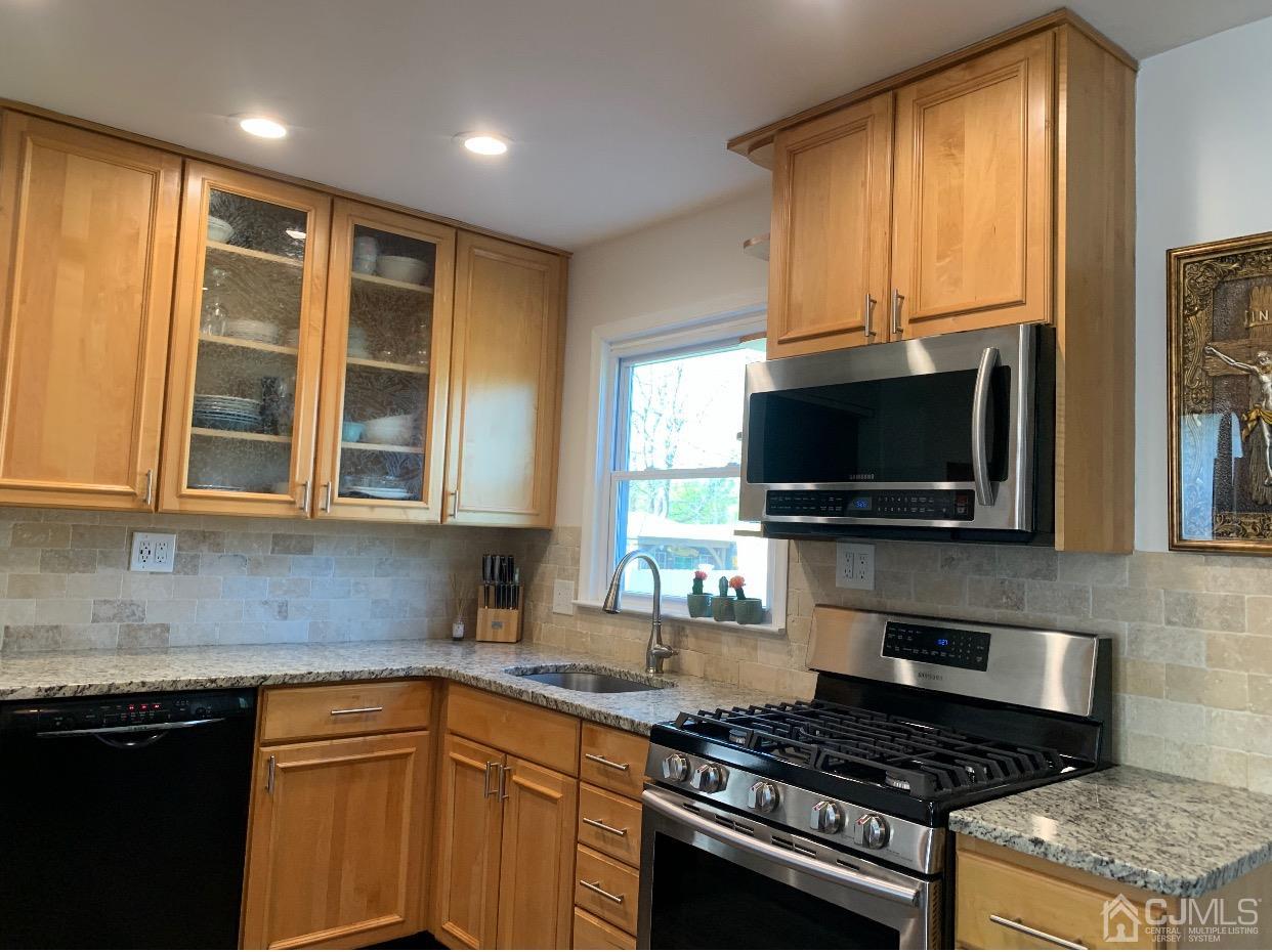 7 Wilshire Road Edison, NJ 08817 - Photo 5 of 14 a kitchen with stainless steel appliances granite countertop a stove a sink and a microwave