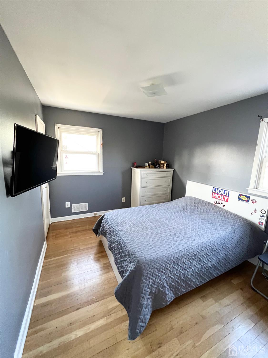 7 Wilshire Road Edison, NJ 08817 - Photo 10 of 14 a bedroom with a bed and a flat screen tv
