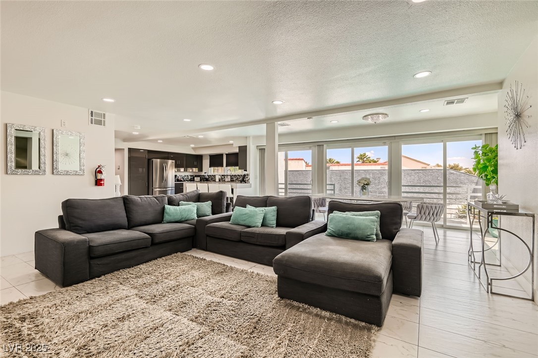 2520 Castlesands Way Las Vegas, NV 89121 - Photo 19 of 59 Living room featuring recessed lighting and a textured ceiling