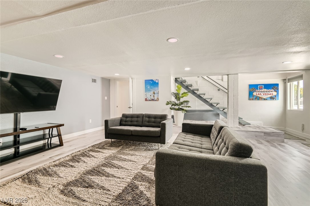2520 Castlesands Way Las Vegas, NV 89121 - Photo 20 of 59 Living area featuring wood finished floors, stairs, recessed lighting, and a textured ceiling