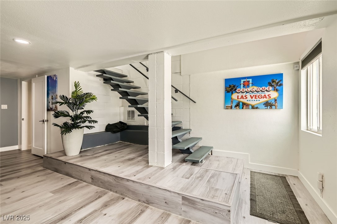 2520 Castlesands Way Las Vegas, NV 89121 - Photo 21 of 59 Stairway featuring wood finished floors, recessed lighting, and a textured ceiling
