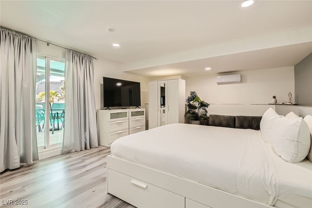 2520 Castlesands Way Las Vegas, NV 89121 - Photo 29 of 59 Bedroom with access to exterior, light wood finished floors, recessed lighting, and a wall mounted AC