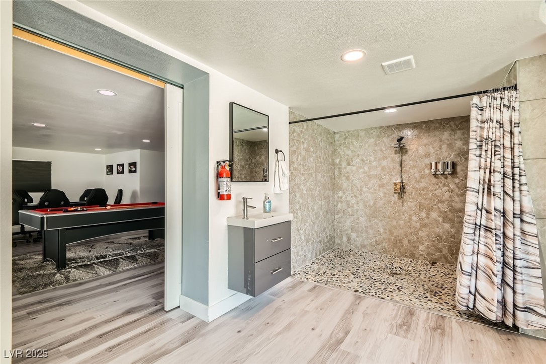 2520 Castlesands Way Las Vegas, NV 89121 - Photo 32 of 59 Full bath with a tile shower, wood finished floors, vanity, and recessed lighting