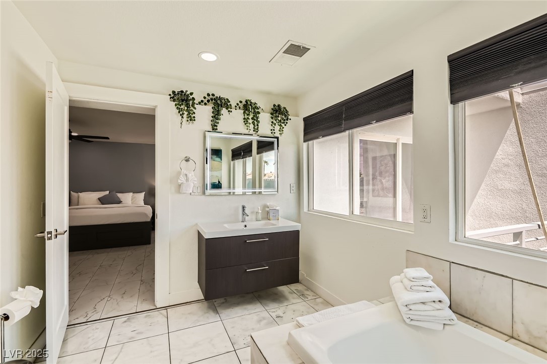 2520 Castlesands Way Las Vegas, NV 89121 - Photo 38 of 59 Ensuite bathroom with marble look tiles, vanity, and recessed lighting