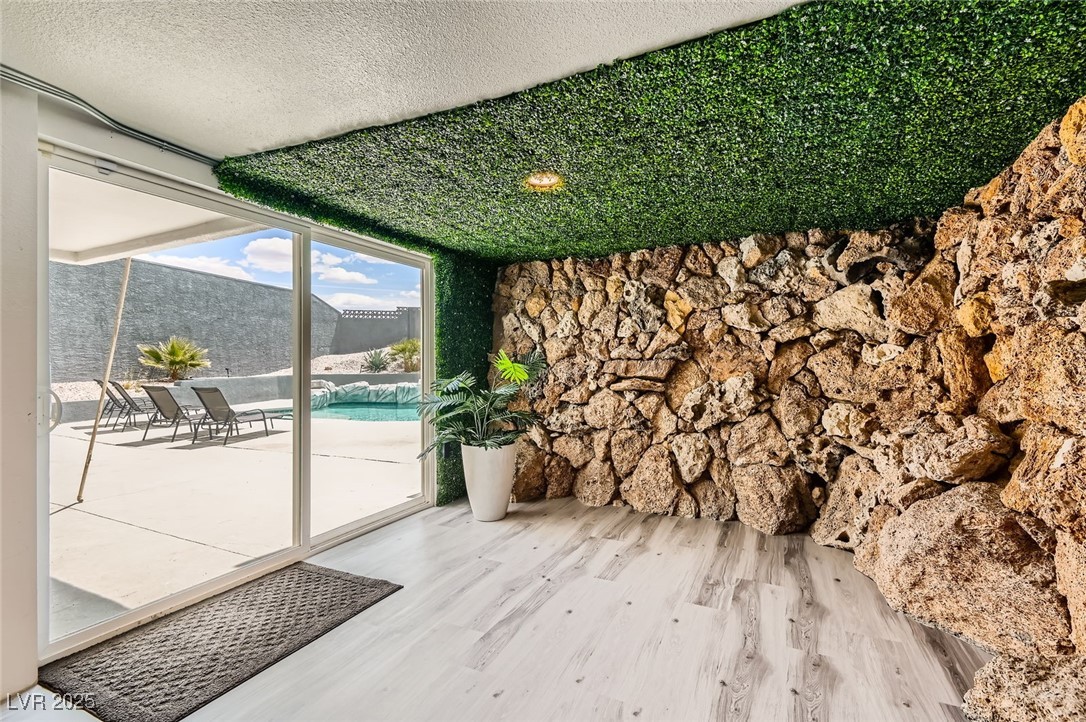 2520 Castlesands Way Las Vegas, NV 89121 - Photo 45 of 59 Doorway to outside featuring wood finished floors, a textured ceiling, floor to ceiling windows, and a sunroom