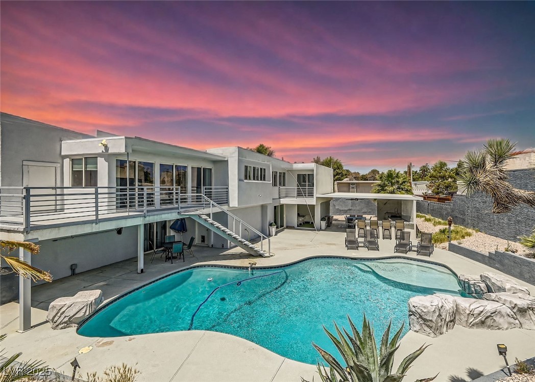 2520 Castlesands Way Las Vegas, NV 89121 - Photo 46 of 59 Pool at dusk featuring a patio area, an outdoor pool, and stairs