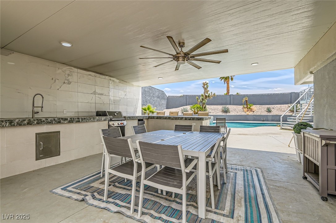 2520 Castlesands Way Las Vegas, NV 89121 - Photo 57 of 59 View of patio featuring exterior kitchen, a ceiling fan, outdoor dining space, and stairs