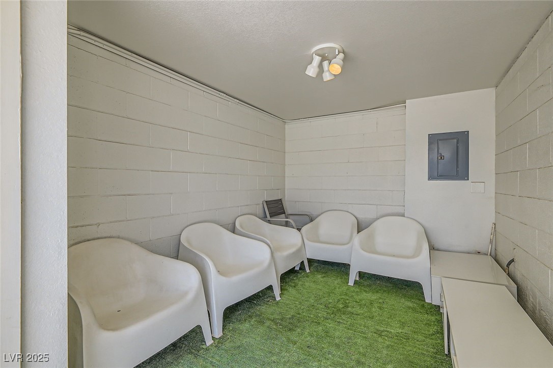 2520 Castlesands Way Las Vegas, NV 89121 - Photo 58 of 59 Sitting room with electric panel, concrete block wall, and carpet flooring