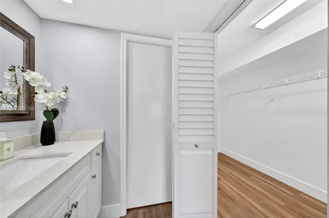 a view of a room with wooden floor and white doors