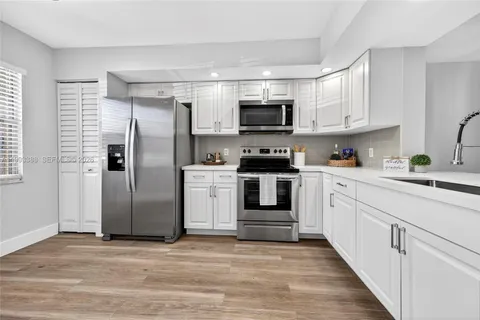 a kitchen with stainless steel appliances a refrigerator stove and sink
