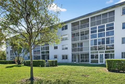 a front view of a building with trees