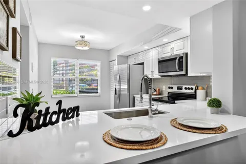a kitchen with stainless steel appliances a sink and cabinets