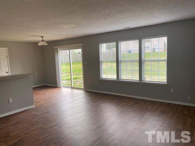 4405 Jordan Oaks Way Raleigh, NC 27604 - Photo 11 of 20 a view of an empty room with wooden floor and a window