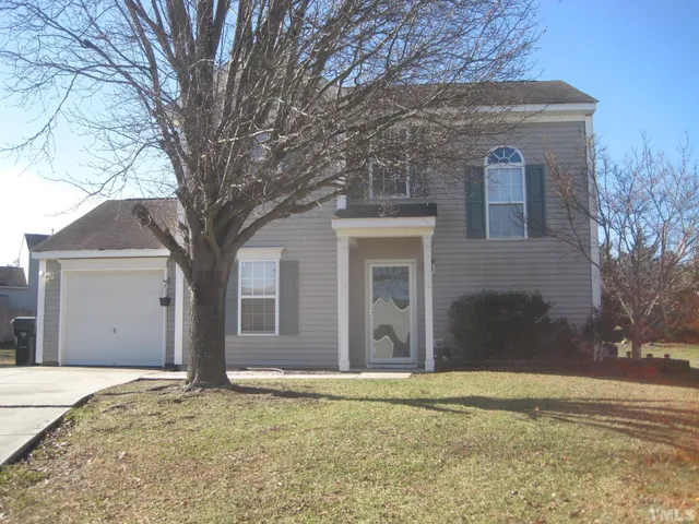 a house that has a tree in front of it