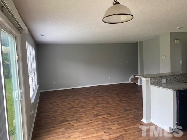 4405 Jordan Oaks Way Raleigh, NC 27604 - Photo 9 of 20 an empty room with wooden floor and windows