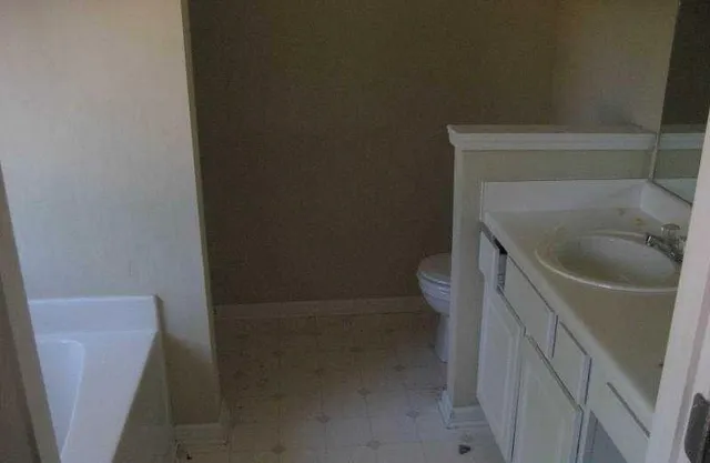 a kitchen with a stove a refrigerator and a sink