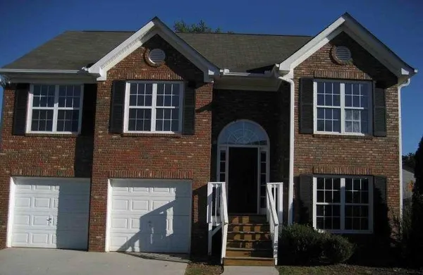 a front view of a house with plants