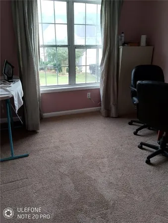 a bed sitting in a bedroom next to a window