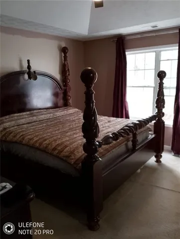 a white toilet sitting next to a white sink and vanity