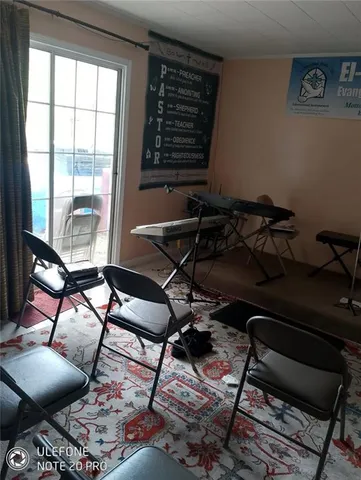 a room with gym equipment and a large window