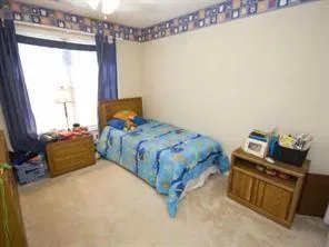 a bedroom with a bed and a mirror