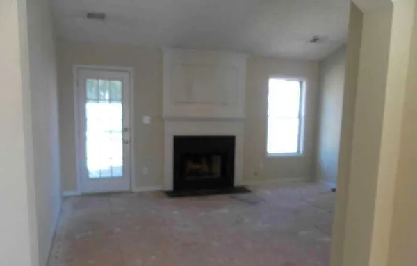 a view of empty room with a fireplace