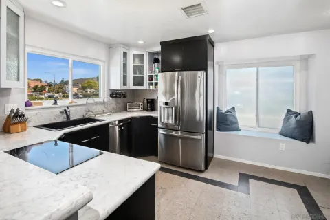 a kitchen with a refrigerator a sink a stove and microwave