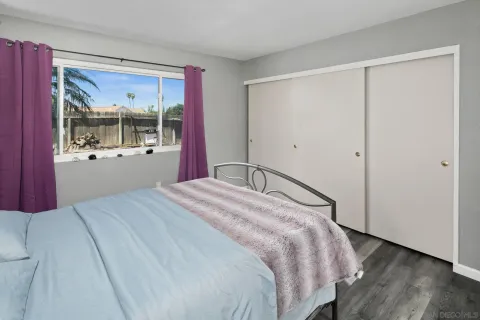 a bedroom with a large bed and a window