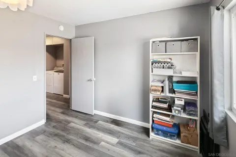 a view of bedroom with wooden floor