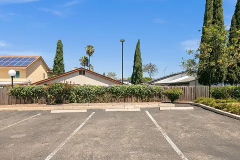 a front view of a house with a yard and potted plants