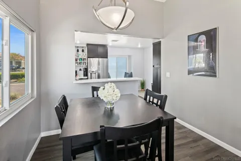 a view of a dining room with furniture a chandelier and wooden floor