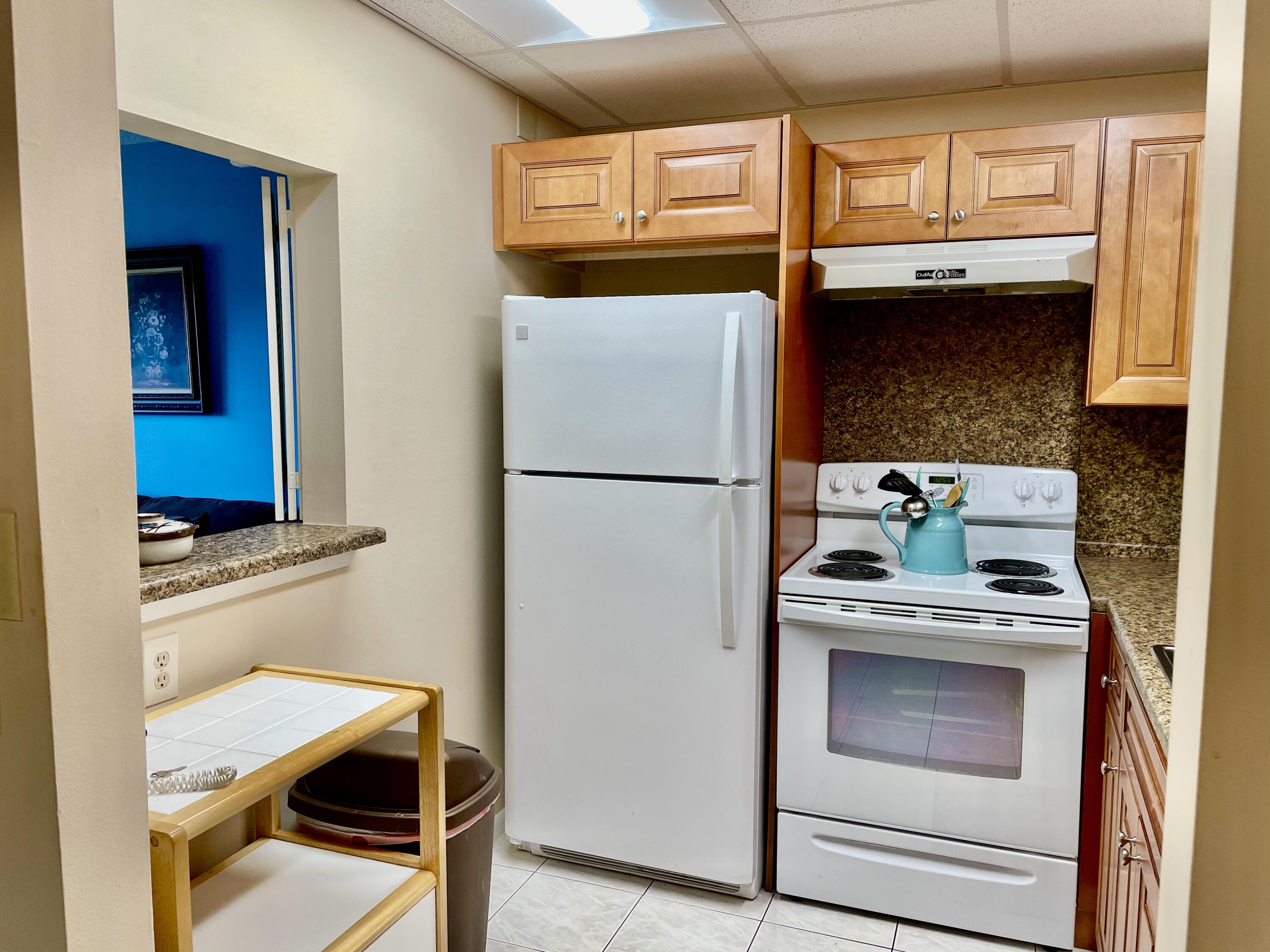 296 Preston H Boca Raton, FL 33434 - Photo 11 of 21 a kitchen with stainless steel appliances granite countertop a refrigerator and a stove