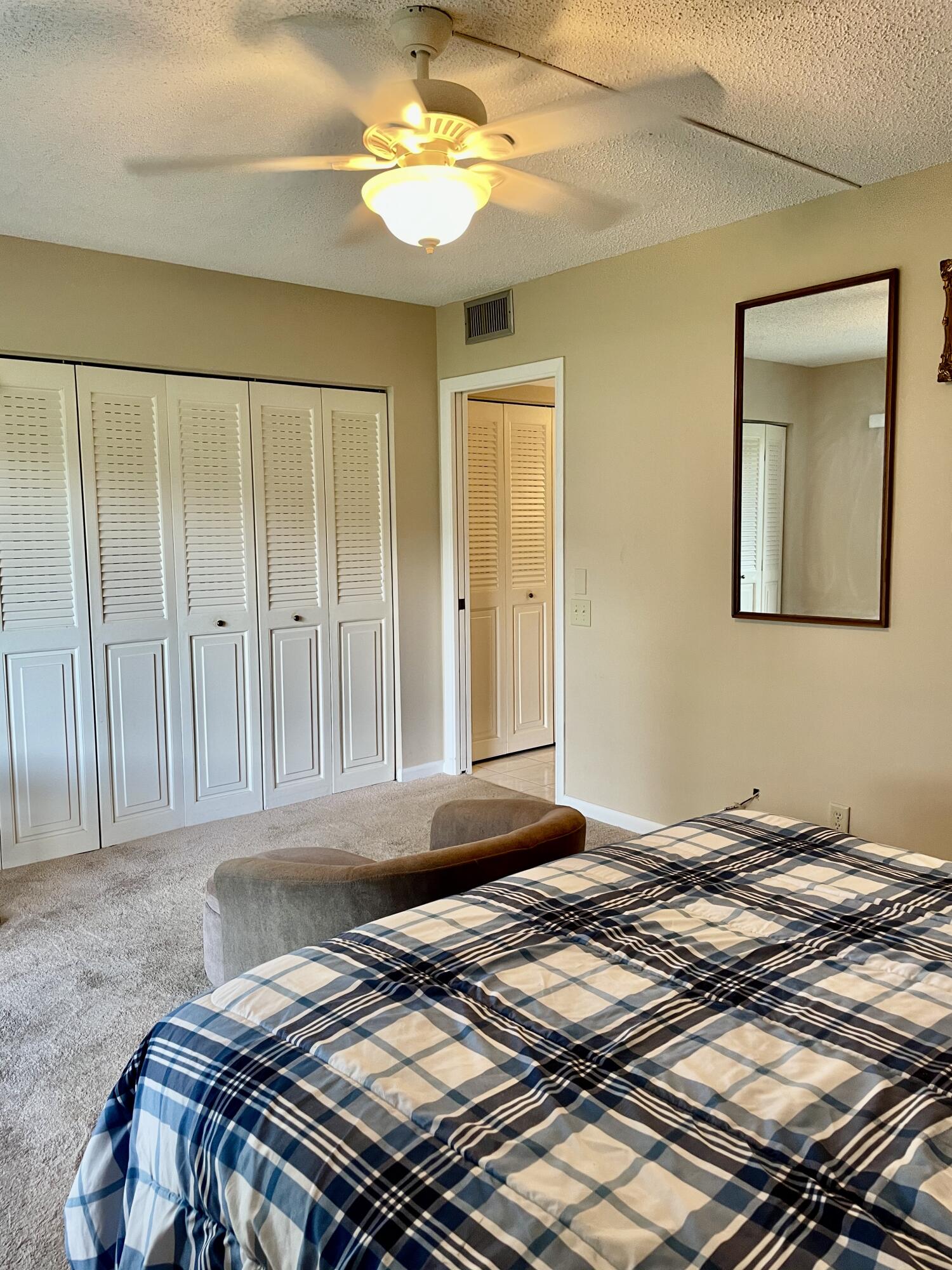 296 Preston H Boca Raton, FL 33434 - Photo 13 of 21 a bedroom with a bed and a chandelier