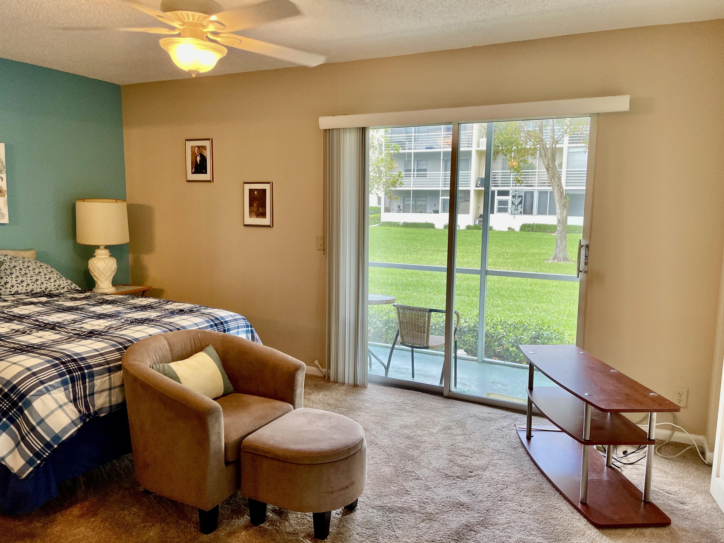 296 Preston H Boca Raton, FL 33434 - Photo 18 of 21 a living room with furniture and a floor to ceiling window