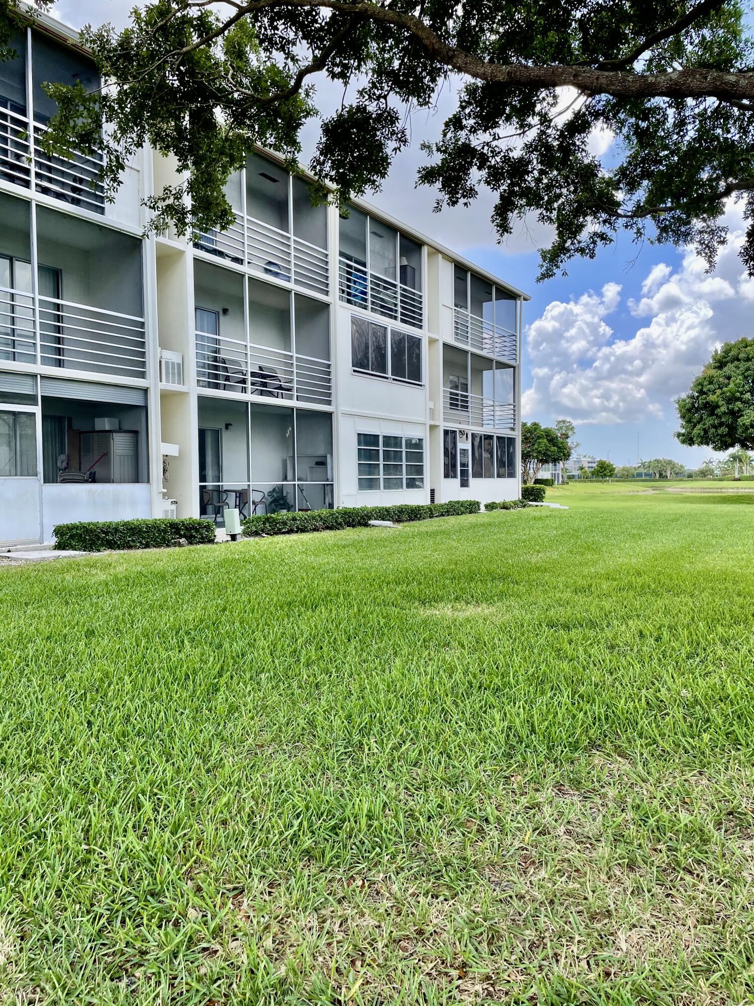 296 Preston H Boca Raton, FL 33434 - Photo 19 of 21 a large building with a yard