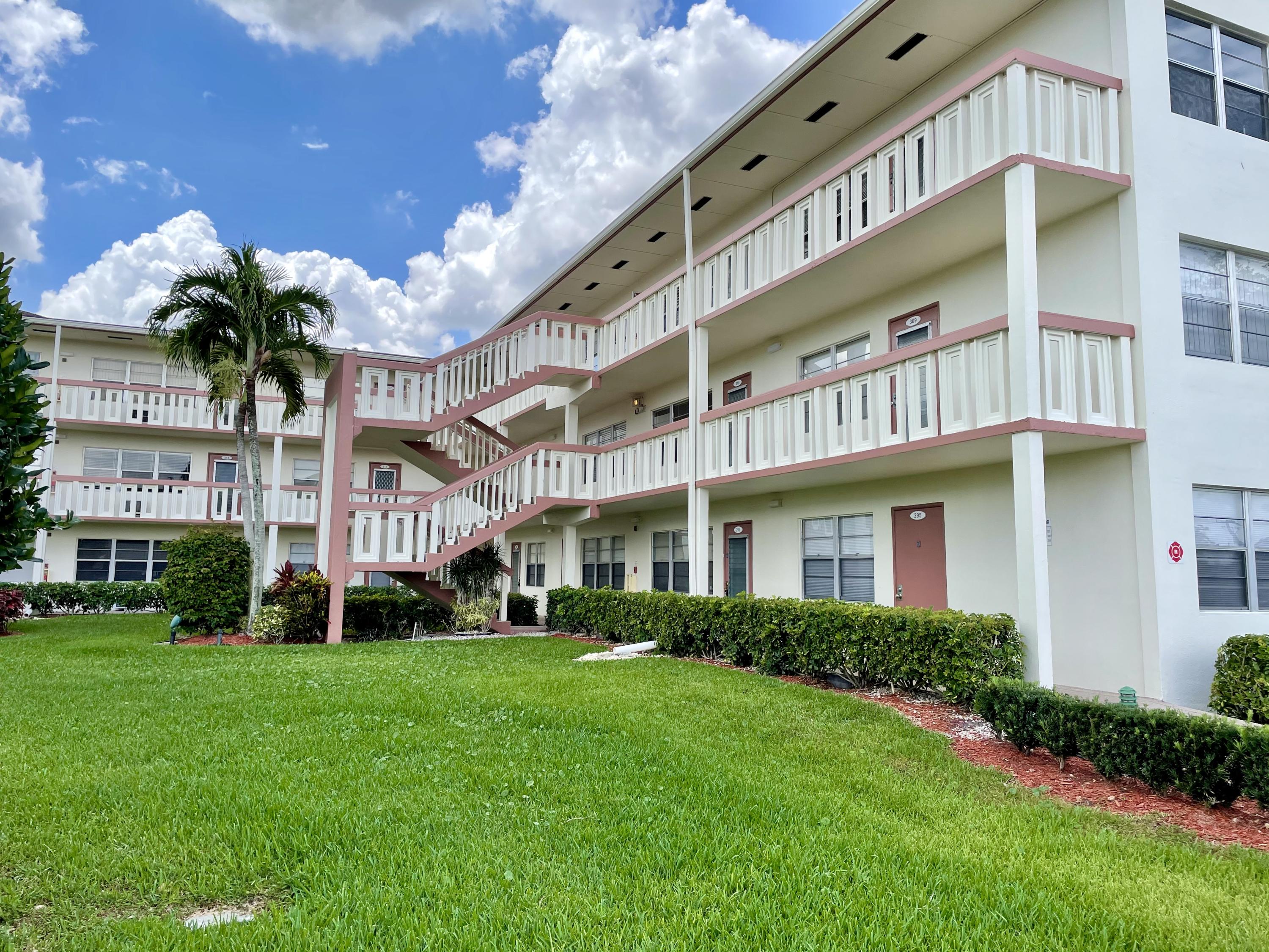 296 Preston H Boca Raton, FL 33434 - Photo 20 of 21 a front view of a building with garden