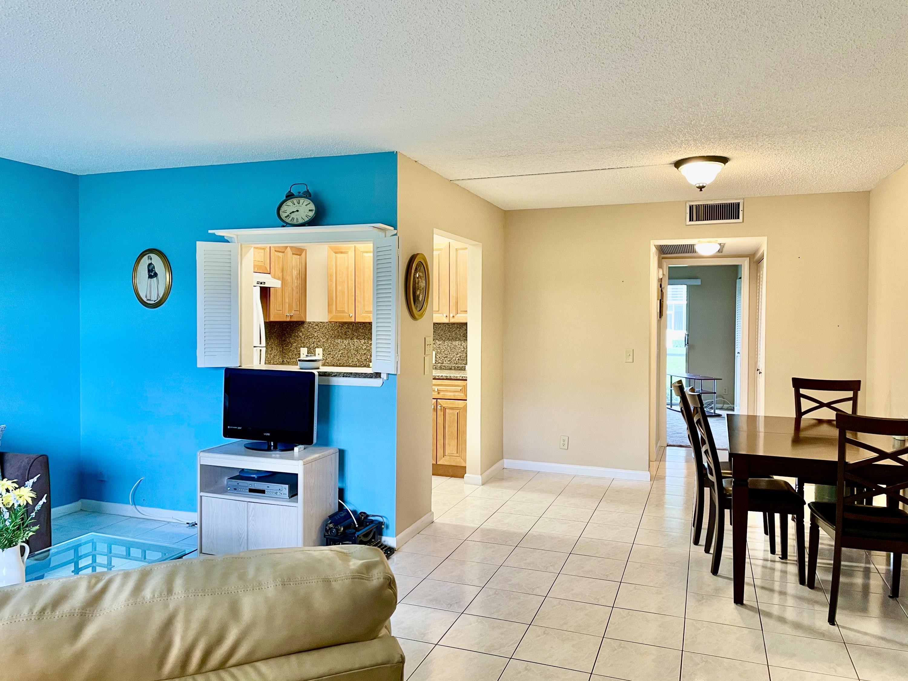 296 Preston H Boca Raton, FL 33434 - Photo 2 of 21 a bedroom with furniture and a flat screen tv