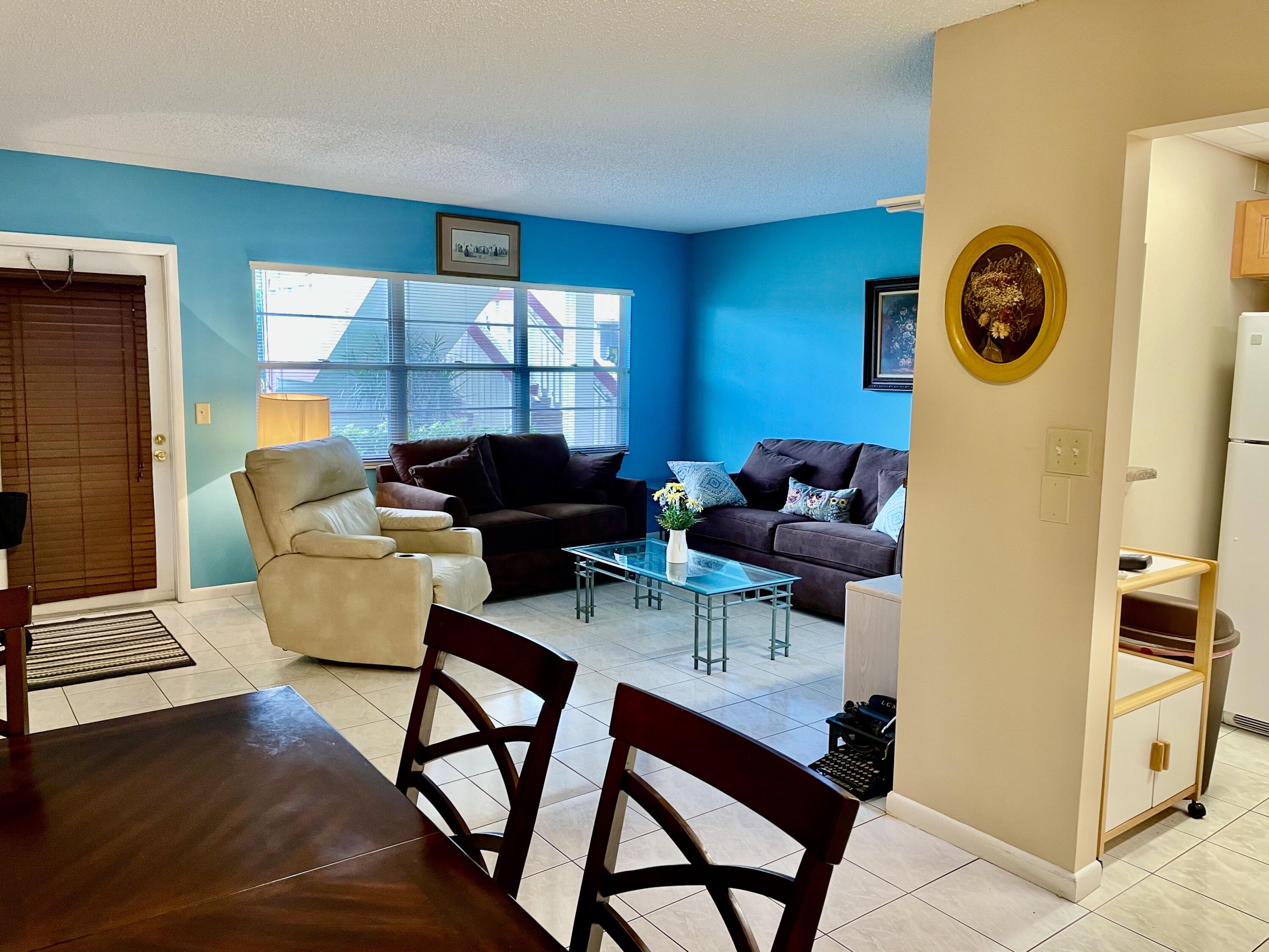 296 Preston H Boca Raton, FL 33434 - Photo 7 of 21 a living room with furniture a rug and a window